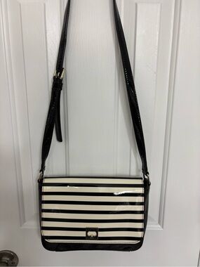 Kate Spade New York Black and White Striped Crossbody Bag with adjustable strap.